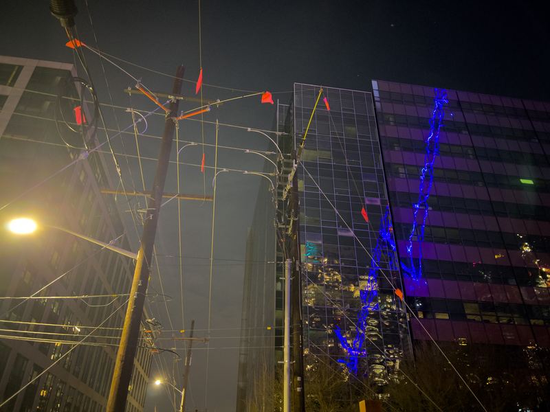 Lights, wires, and a crane reflected, Seattle
